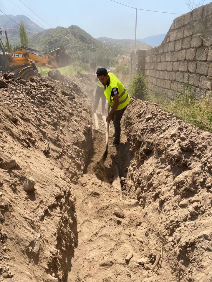 Excavator digging a trench