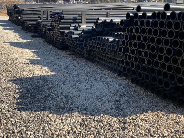 HDPE pipes stacked in a storage yard