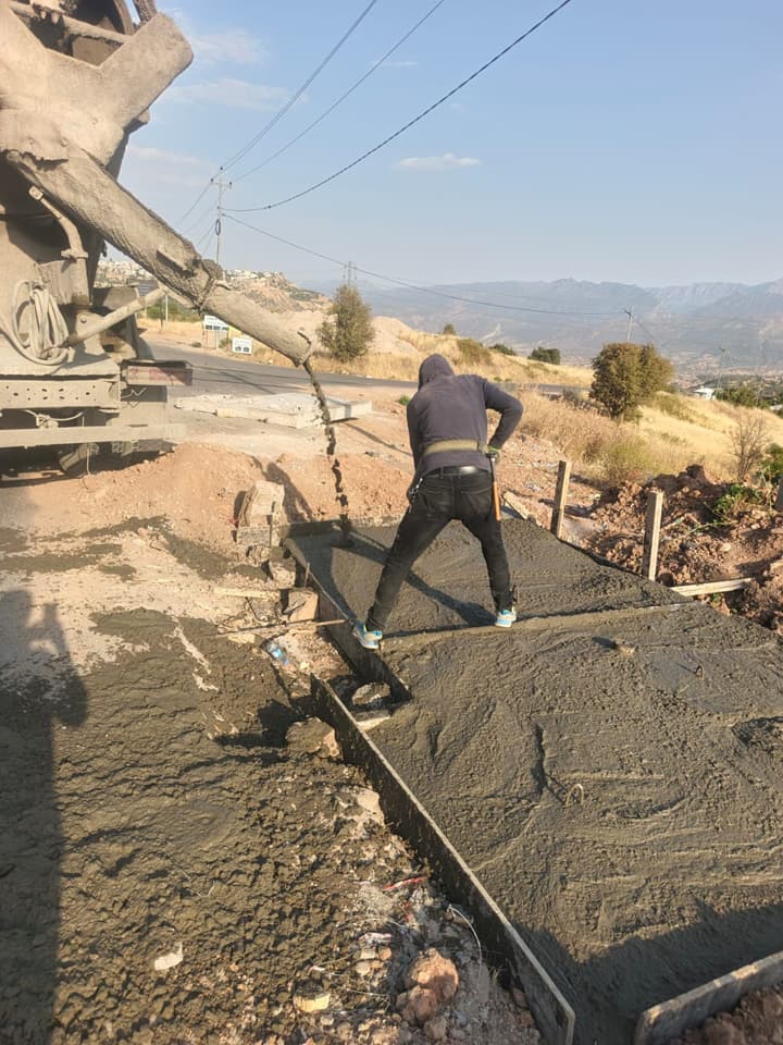 Workers installing pipe in a trench