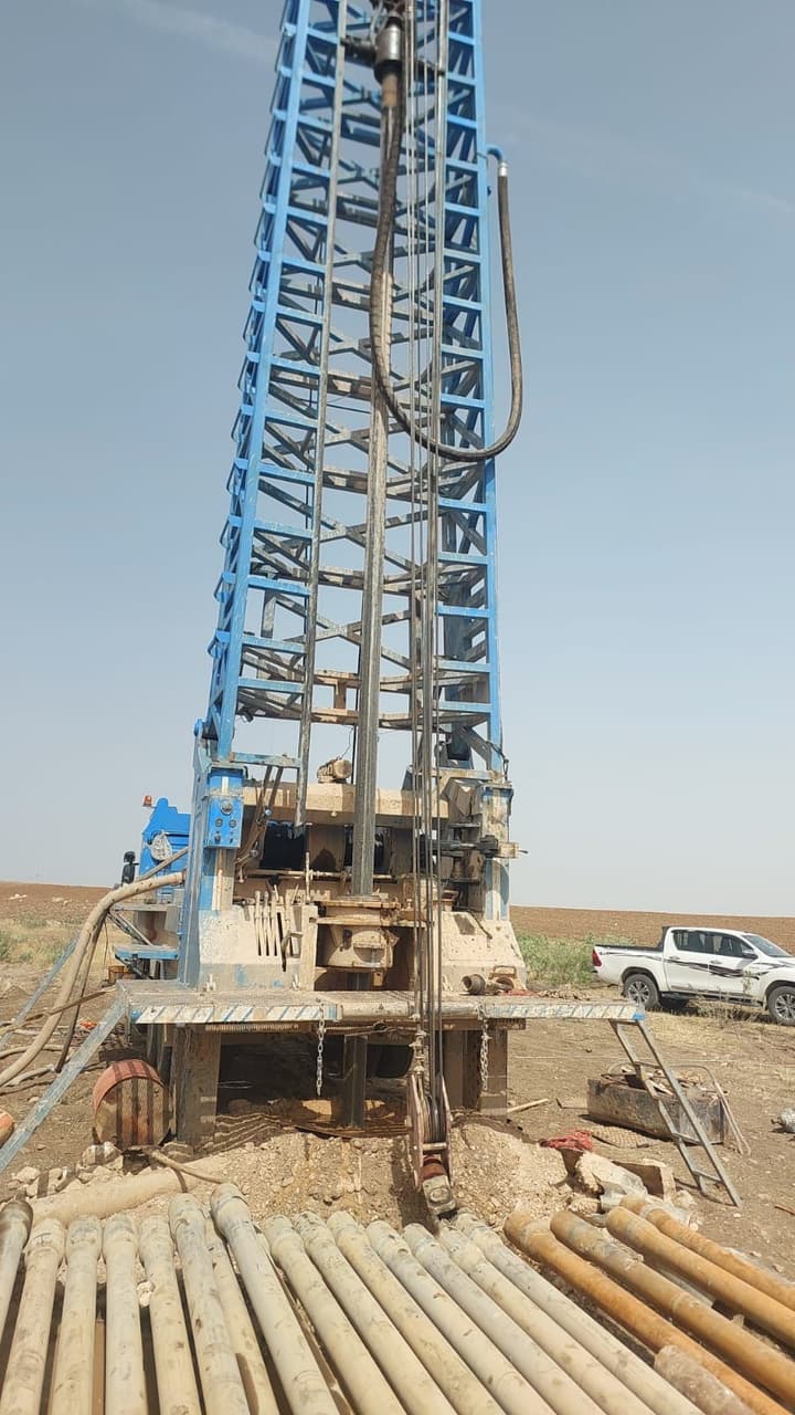 Workers installing pipe in a trench