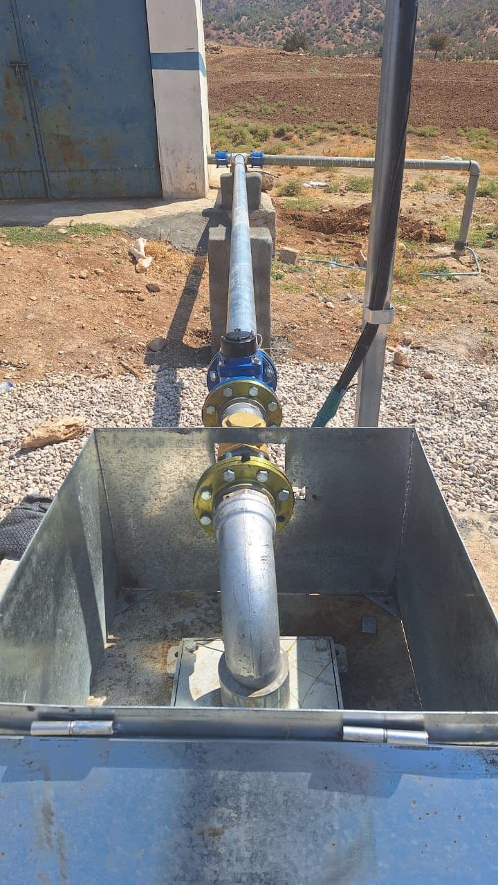 Workers installing pipe in a trench