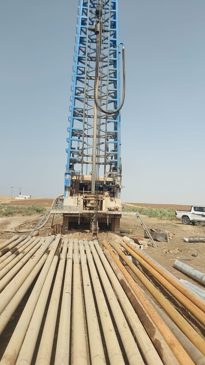 Workers installing pipe in a trench