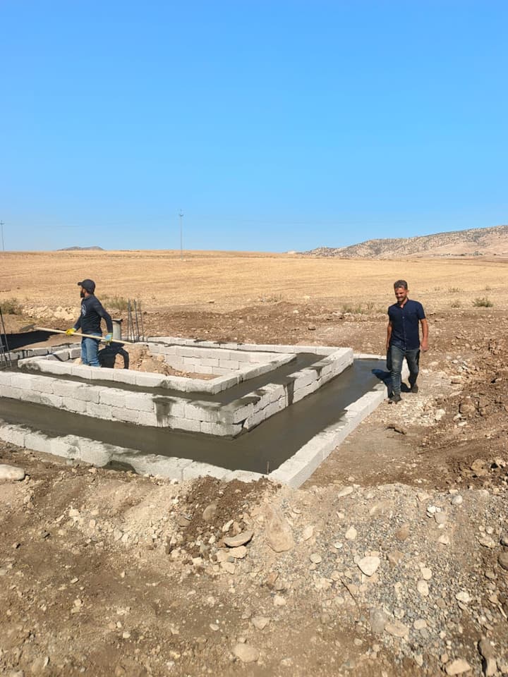 Workers installing pipe in a trench
