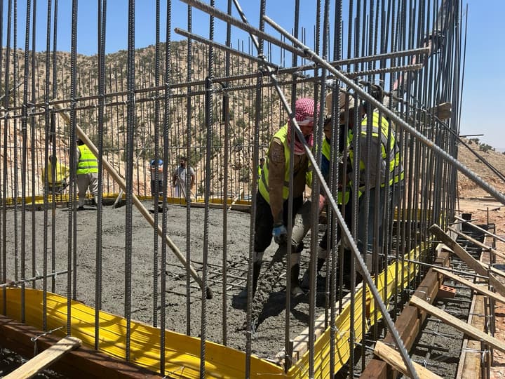 Workers in safety vests on a job site