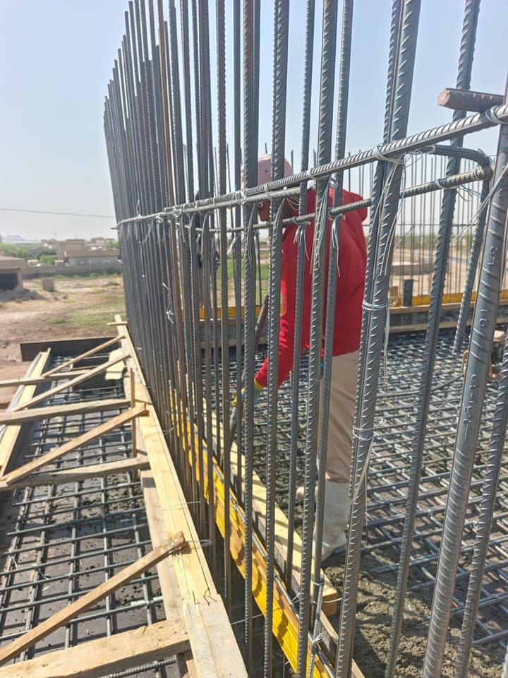 Workers in safety vests on a job site